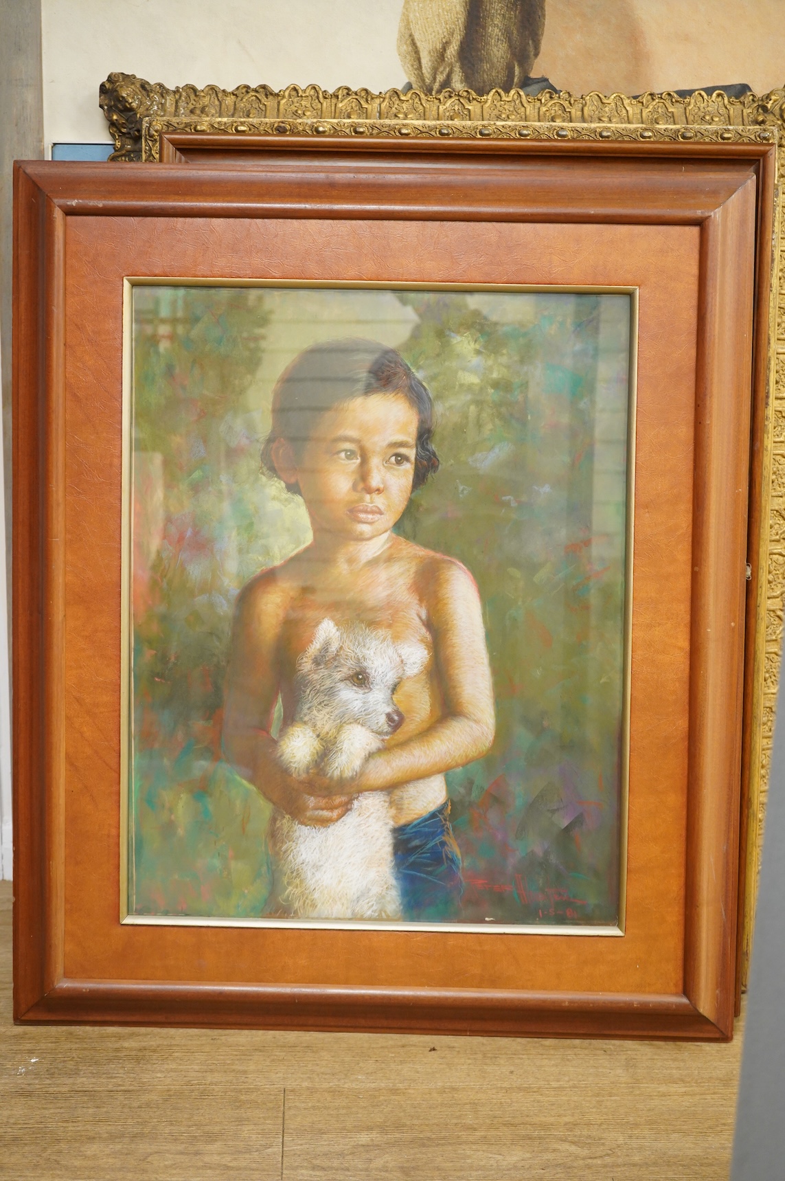 20th century, Portrait of a young Thai girl holding a puppy, indistinctly signed and dated 1981 together with a similar pastel of a young boy holding a dog, indistinctly signed and dated '82, largest 70 x 54cm